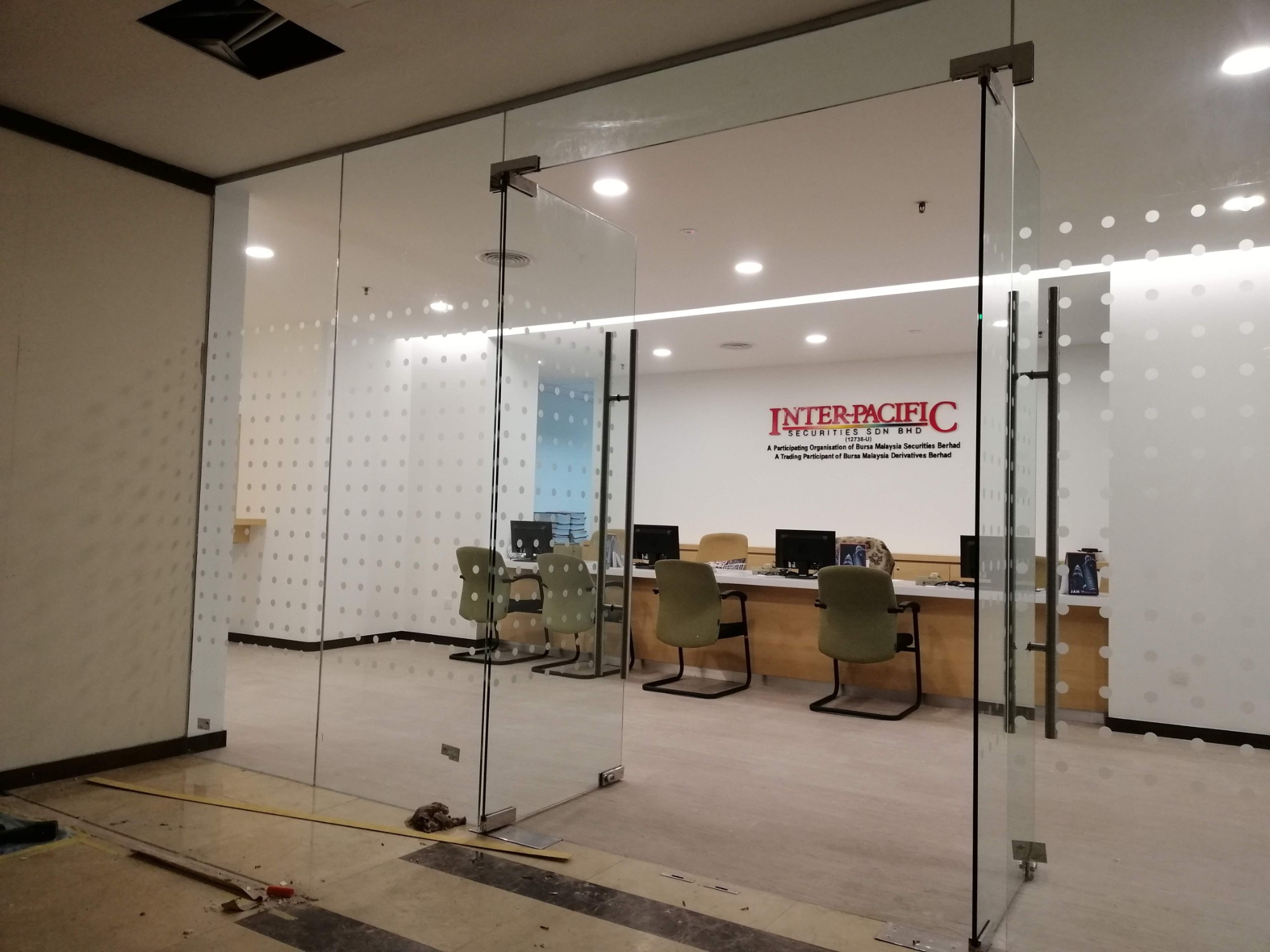 Inter-Pacific Securities office with glass partitions by Hypro Renovation