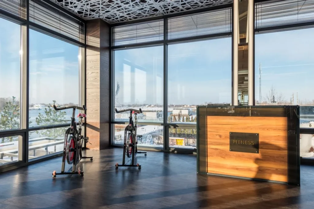 Fitness studio with full-height glass partition windows and exercise bikes